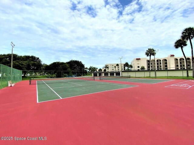 5807 N Atlantic Ave Unit 521, Cape Canaveral, FL 32920 - view of tennis court with fence and community basketball court