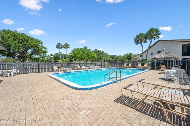 5807 N Atlantic Ave Unit 521, Cape Canaveral, FL 32920 - community pool with a patio and fence