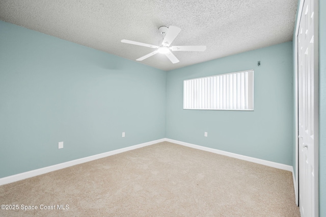 5807 N Atlantic Ave Unit 521, Cape Canaveral, FL 32920 - carpeted spare room featuring a ceiling fan, baseboards, and a textured ceiling