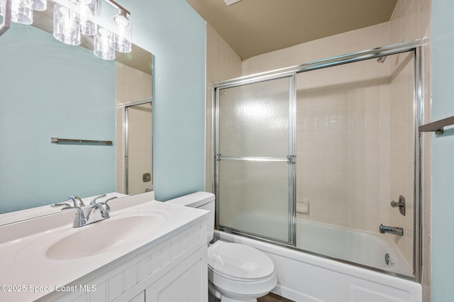 5807 N Atlantic Ave Unit 521, Cape Canaveral, FL 32920 - bathroom featuring toilet, shower / bath combination with glass door, and vanity