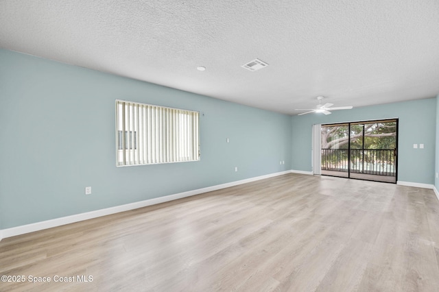 5807 N Atlantic Ave Unit 521, Cape Canaveral, FL 32920 - unfurnished room with a ceiling fan, light wood finished floors, a textured ceiling, and baseboards