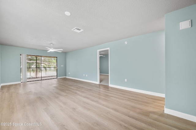 5807 N Atlantic Ave Unit 521, Cape Canaveral, FL 32920 - unfurnished room featuring a textured ceiling, light wood finished floors, ceiling fan, and baseboards