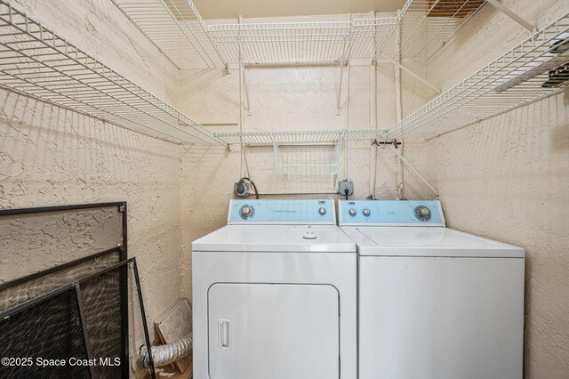 5807 N Atlantic Ave Unit 521, Cape Canaveral, FL 32920 - washroom with separate washer and dryer and a textured wall