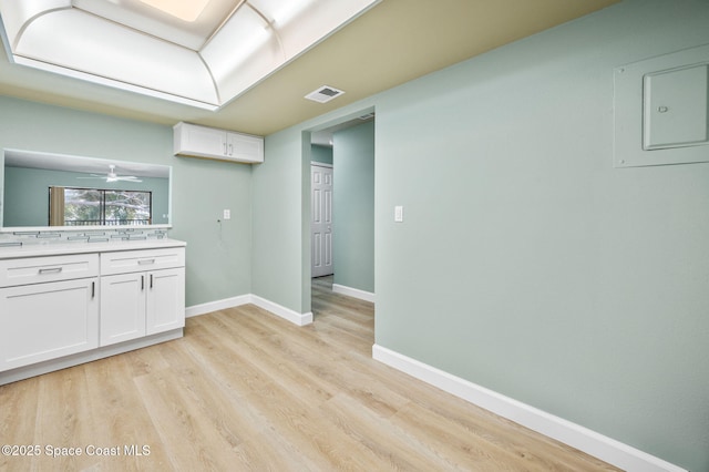 5807 N Atlantic Ave Unit 521, Cape Canaveral, FL 32920 - bar featuring light wood-style flooring, baseboards, and electric panel