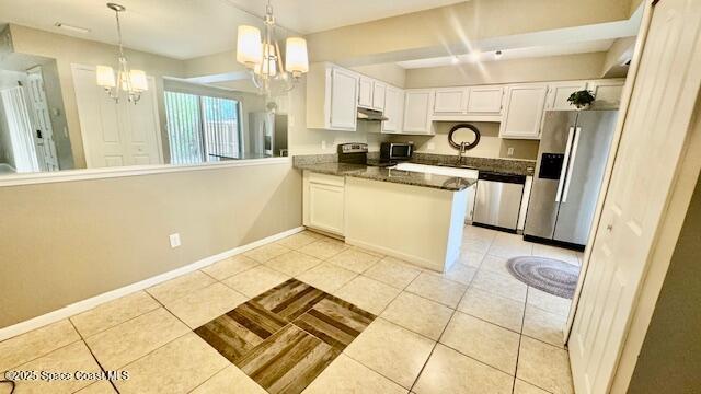 1648 S Park Ave, Titusville, FL 32780 - kitchen featuring appliances with stainless steel finishes, a chandelier, and light tile patterned flooring