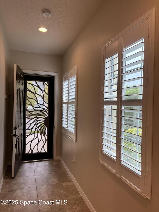 3455 Sedge Dr, Rockledge, FL 32955 - doorway with a textured ceiling, recessed lighting, and tile patterned flooring