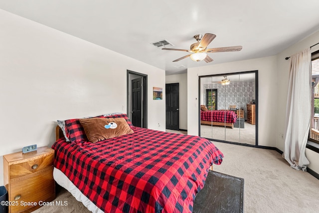 carpeted bedroom with access to exterior, multiple windows, a ceiling fan, and baseboards
