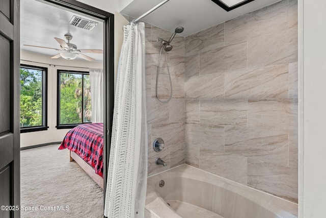 ensuite bathroom with shower / bath combo and ceiling fan