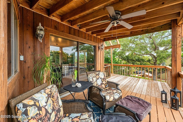wooden deck featuring a ceiling fan