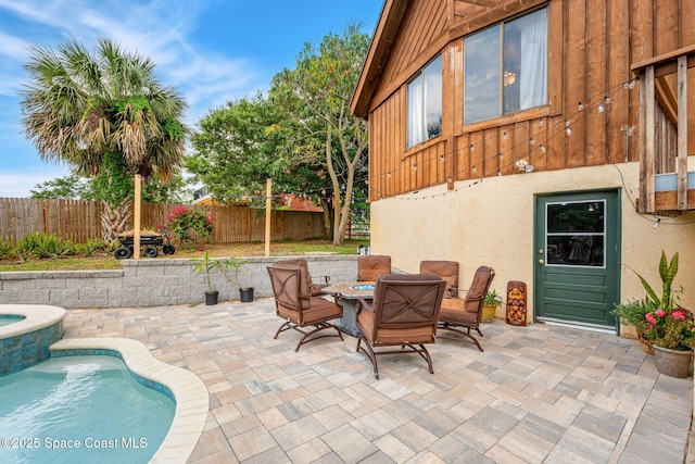 view of patio / terrace featuring a fenced backyard and an in-ground hot tub