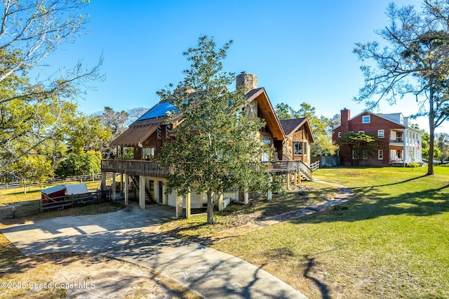 view of side of property with a deck, driveway, and stairway