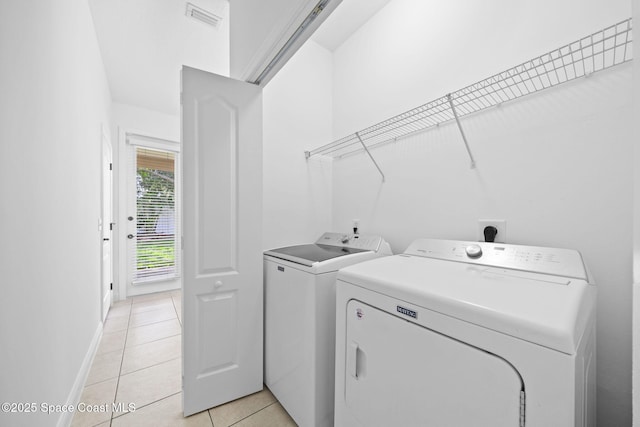 504 Glenbrook Cir, Rockledge, FL 32955 - washroom with washer and dryer, light tile patterned floors, and baseboards