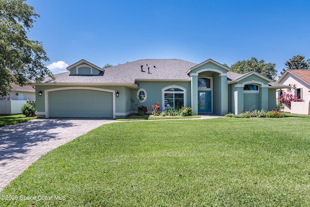 1132 Cypress Trace Dr, Melbourne, FL 32940 - mediterranean / spanish home with an attached garage, stucco siding, decorative driveway, and a shingled roof