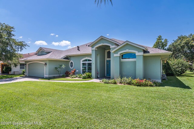 1132 Cypress Trace Dr, Melbourne, FL 32940 - view of front of house with stucco siding, a garage, a front lawn, concrete driveway, and roof with shingles