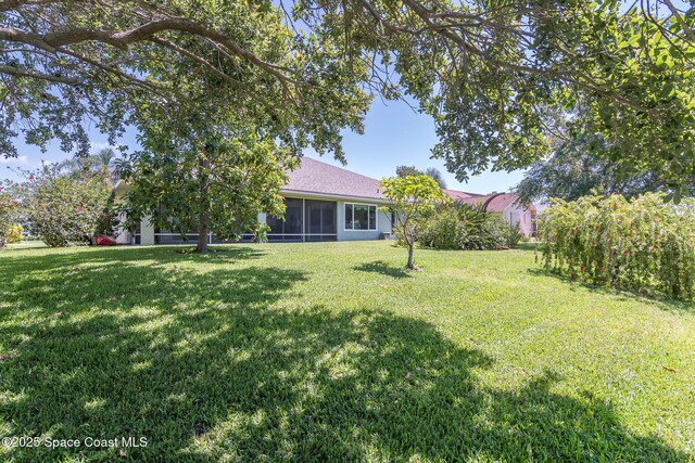 1132 Cypress Trace Dr, Melbourne, FL 32940 - view of green lawn featuring a sunroom
