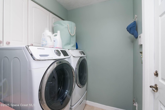1132 Cypress Trace Dr, Melbourne, FL 32940 - laundry room featuring washer and clothes dryer, cabinet space, and baseboards