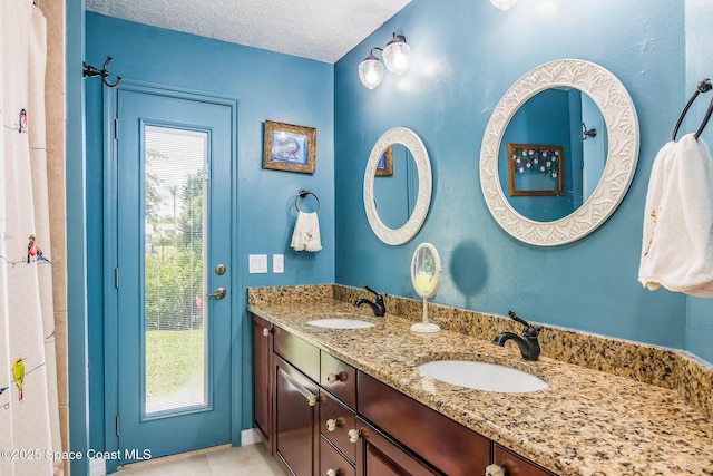 1132 Cypress Trace Dr, Melbourne, FL 32940 - full bathroom with a textured ceiling, double vanity, and tile patterned flooring