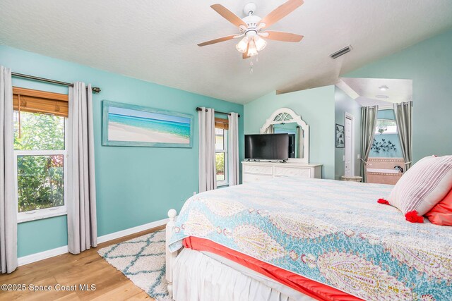 1132 Cypress Trace Dr, Melbourne, FL 32940 - bedroom featuring multiple windows, lofted ceiling, wood finished floors, baseboards, and a ceiling fan