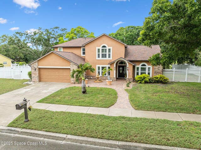 2449 Willowbrook Rd, Merritt Island, FL 32952 - traditional home featuring stucco siding, a garage, concrete driveway, and a shingled roof