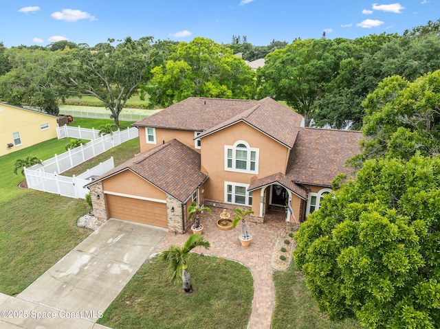 2449 Willowbrook Rd, Merritt Island, FL 32952 - traditional home featuring stucco siding, an attached garage, and driveway