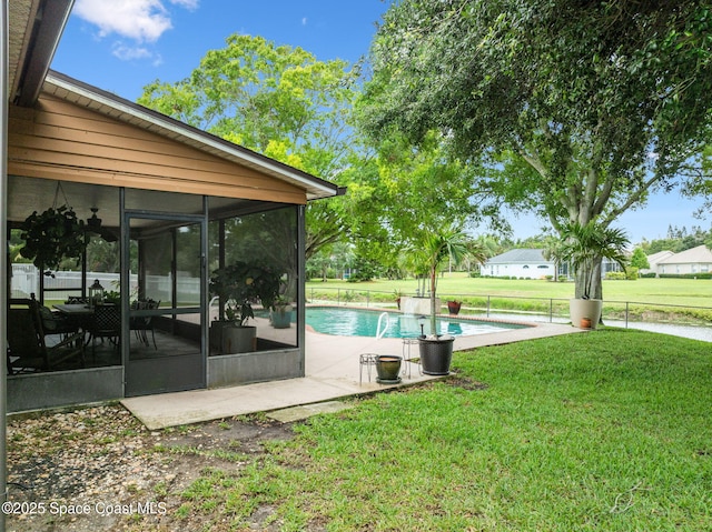 2449 Willowbrook Rd, Merritt Island, FL 32952 - outdoor pool with a sunroom, a yard, and a patio area