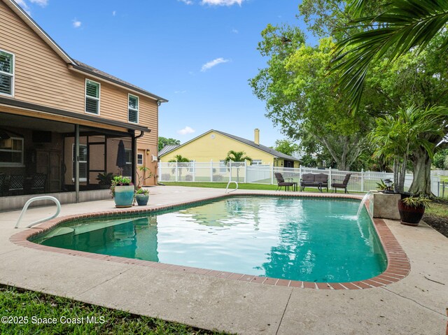 2449 Willowbrook Rd, Merritt Island, FL 32952 - view of pool with a patio, a fenced backyard, and a sunroom