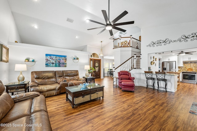 2449 Willowbrook Rd, Merritt Island, FL 32952 - living area featuring a ceiling fan, stairway, high vaulted ceiling, wood finished floors, and recessed lighting