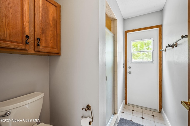 2449 Willowbrook Rd, Merritt Island, FL 32952 - bathroom featuring a stall shower, toilet, baseboards, and tile patterned flooring