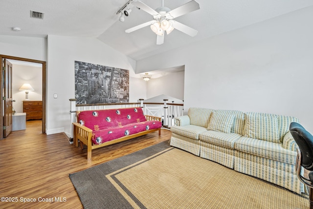 2449 Willowbrook Rd, Merritt Island, FL 32952 - living room with wood finished floors, vaulted ceiling, a ceiling fan, track lighting, and baseboards