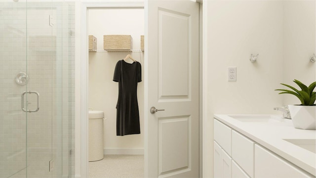 2432 Antarus Dr NW, Palm Bay, FL 32907 - bathroom featuring a sink, tile patterned floors, a shower stall, double vanity, and baseboards