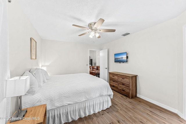bedroom with baseboards, wood finished floors, and ceiling fan