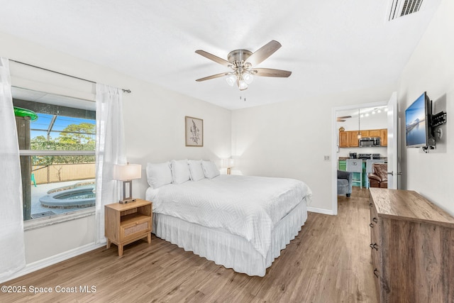 bedroom featuring light wood-style flooring, baseboards, and ceiling fan