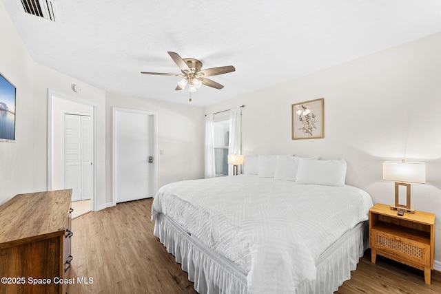 bedroom featuring wood finished floors, ceiling fan, and baseboards