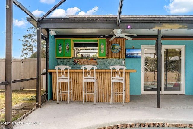 sunroom / solarium with a ceiling fan