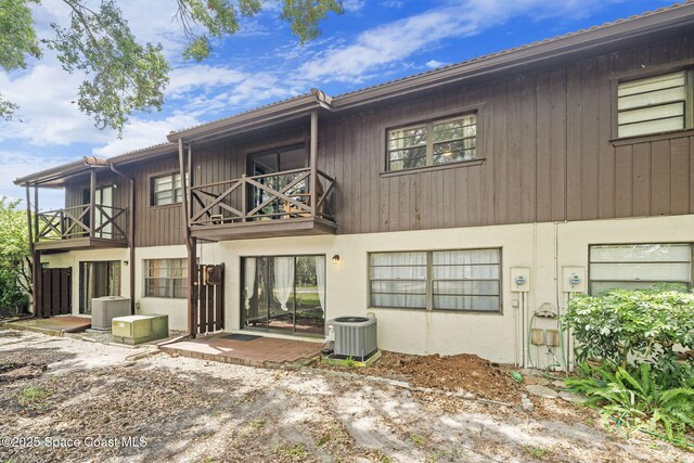 255 S Tropical Trl Unit B3, Merritt Island, FL 32952 - back of house with central air condition unit and a balcony