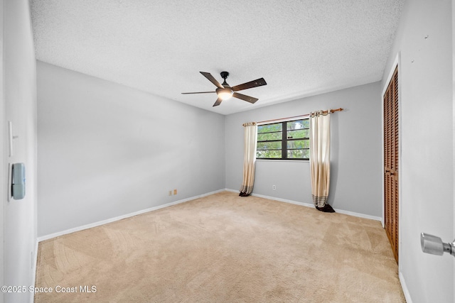 255 S Tropical Trl Unit B3, Merritt Island, FL 32952 - carpeted empty room with a ceiling fan, a textured ceiling, and baseboards