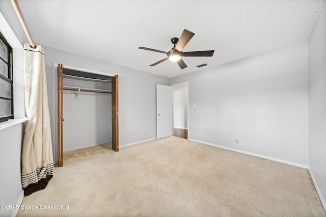 255 S Tropical Trl Unit B3, Merritt Island, FL 32952 - unfurnished bedroom featuring carpet floors, a closet, baseboards, and ceiling fan