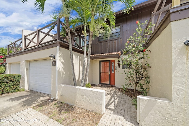 255 S Tropical Trl Unit B3, Merritt Island, FL 32952 - view of front of home with a balcony, driveway, stucco siding, and an attached garage