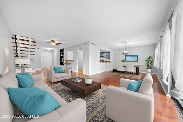 255 S Tropical Trl Unit B3, Merritt Island, FL 32952 - living room featuring wood finished floors, baseboards, a chandelier, and ceiling fan