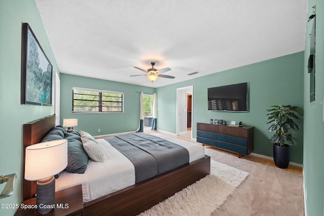 255 S Tropical Trl Unit B3, Merritt Island, FL 32952 - bedroom with wood finished floors, baseboards, and a ceiling fan