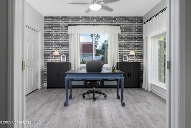 175 Stewart Dr, Merritt Island, FL 32952 - office with ceiling fan, light wood finished floors, and brick wall