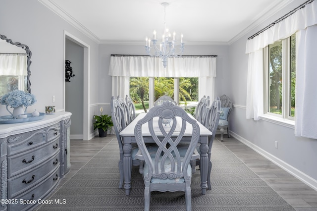 175 Stewart Dr, Merritt Island, FL 32952 - dining space with a chandelier, crown molding, light wood-style flooring, and baseboards