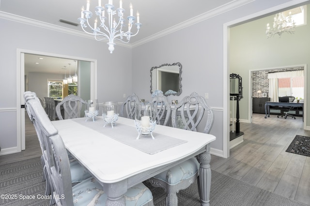 175 Stewart Dr, Merritt Island, FL 32952 - dining room with a chandelier, wood finished floors, crown molding, and baseboards