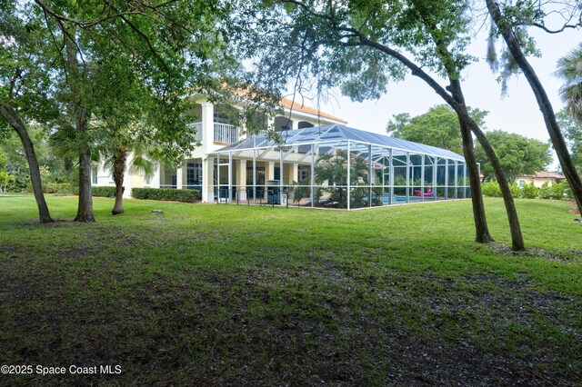 175 Stewart Dr, Merritt Island, FL 32952 - view of grassy yard with glass enclosure and an outdoor pool