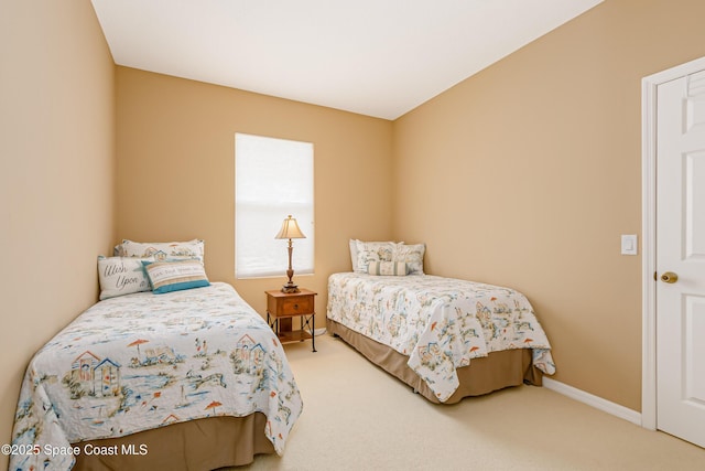 carpeted bedroom featuring baseboards