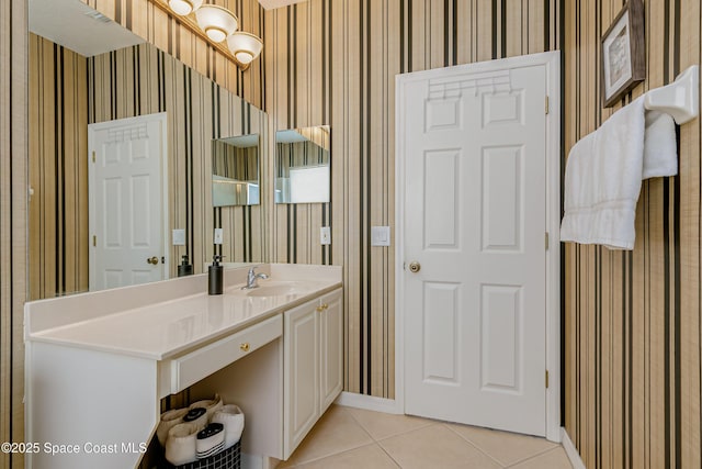 bathroom featuring wallpapered walls, tile patterned flooring, vanity, and baseboards