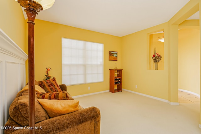 sitting room with carpet and baseboards
