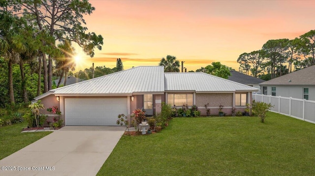 326 Brescia St NE, Palm Bay, FL 32907 - view of front facade featuring an attached garage, driveway, stucco siding, and metal roof