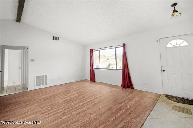 326 Brescia St NE, Palm Bay, FL 32907 - entrance foyer featuring light wood-type flooring, a textured ceiling, and baseboards