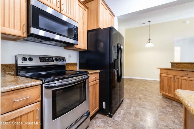 5230 Everett St, Cocoa, FL 32927 - kitchen with stainless steel appliances, baseboards, hanging light fixtures, and light brown cabinets